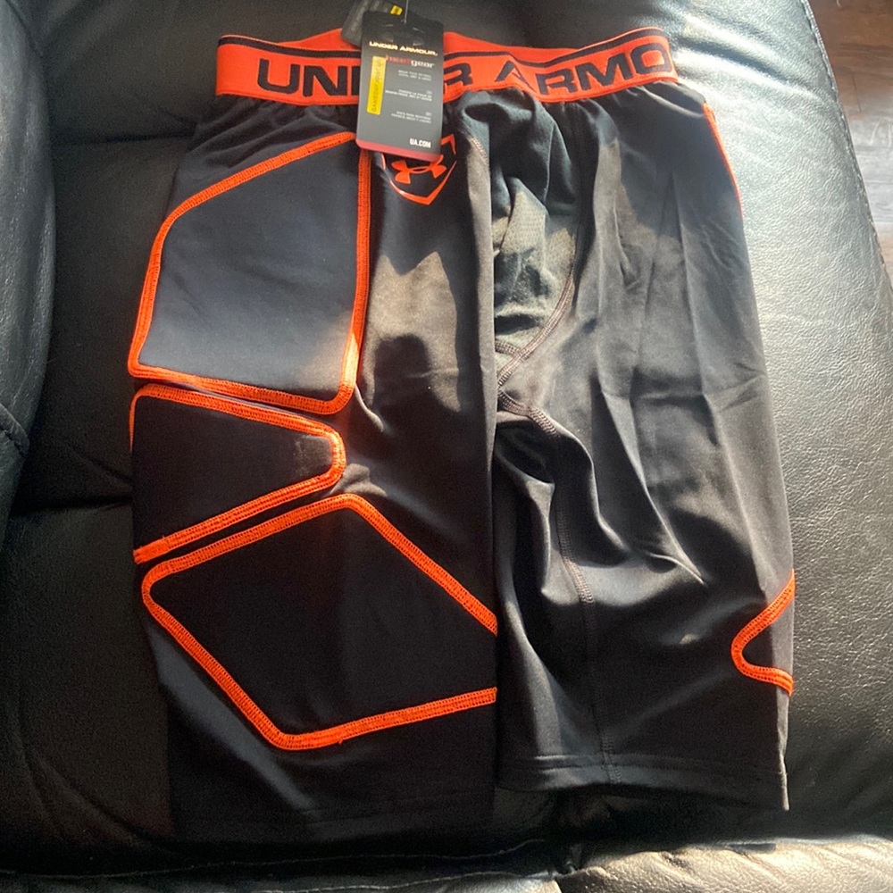 Orange and black under armour compression shorts.